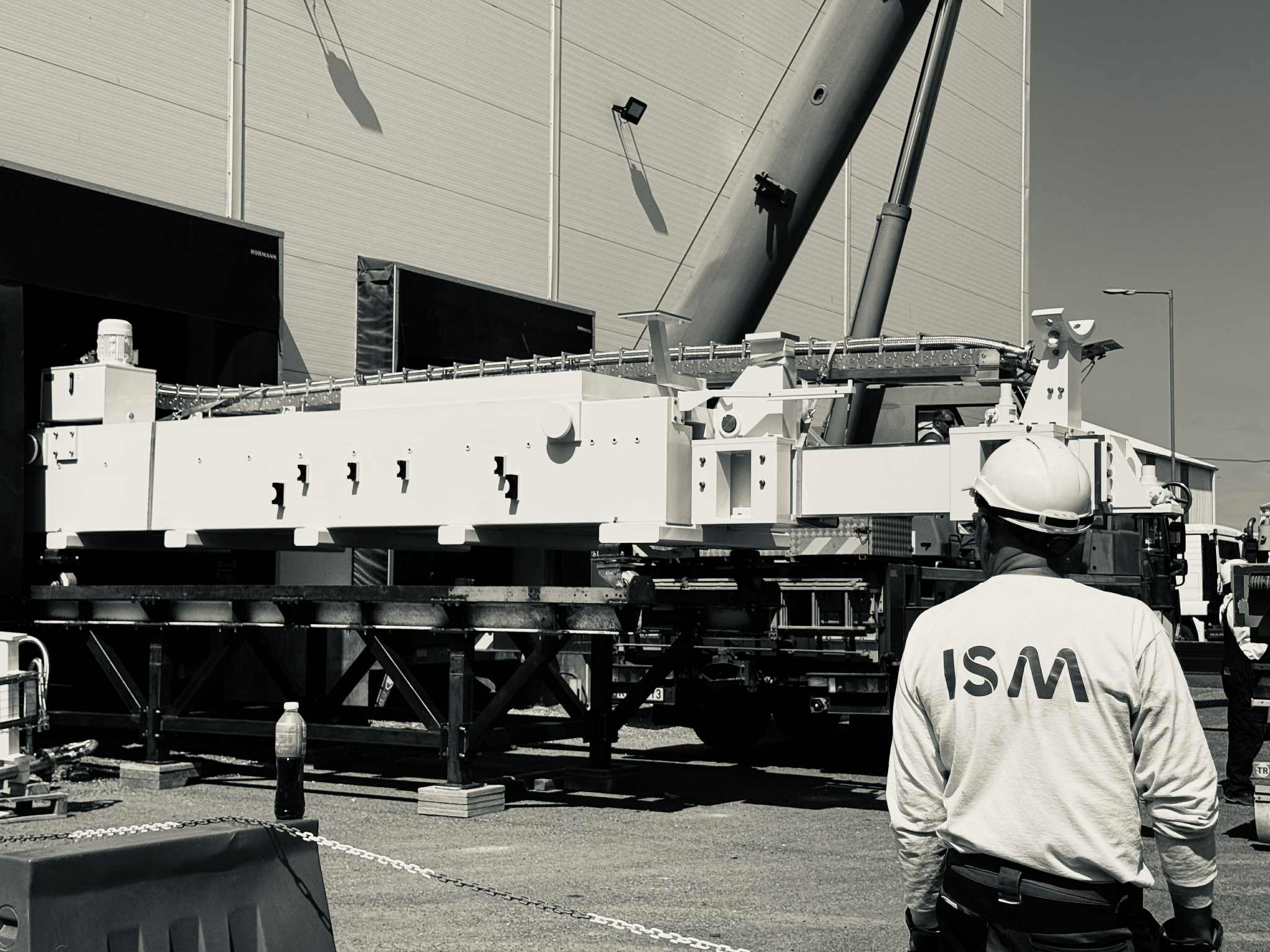 ISM fitter positioning a large installation with a crane